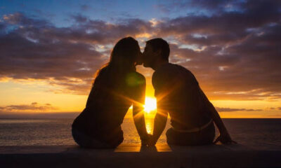 A close-up of a couple kissing, highlighting the risks of diseases transmitted through saliva.